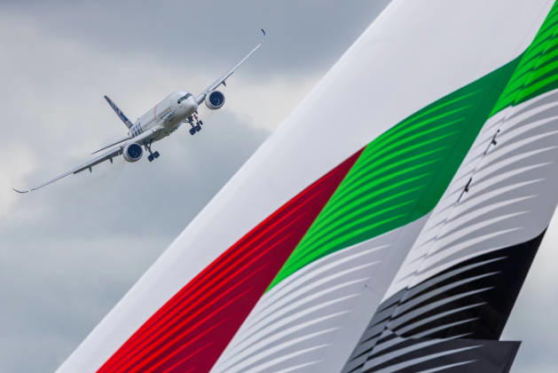 Trade visitor day at ILA Berlin 2026, Berlin, 12 06 2026 An Airbus A350 1000 with ANA livery on low approach, in the foreground the striking tail unit of an Emirates Airbus A380 in the colors of the United Arab Emirates Both aircraft are part of the flight demonstrations at ILA 2026 Schöneberg Berlin ExpoCenter Airport Brandenburg Germany 20260612-1V9A1834-M4000