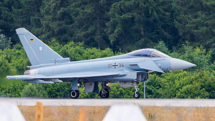 Trade visitor day at ILA Berlin 2026, Berlin, 12 06 2026 A German Air Force Eurofighter Typhoon with the registration number 31 34 taxis on the tarmac The fighter aircraft bears the Iron Cross of the German Armed Forces and the German flag on the vertical tail Schöneberg Berlin ExpoCenter Airport Brandenburg Germany 20260612-1V9A2503-M4000