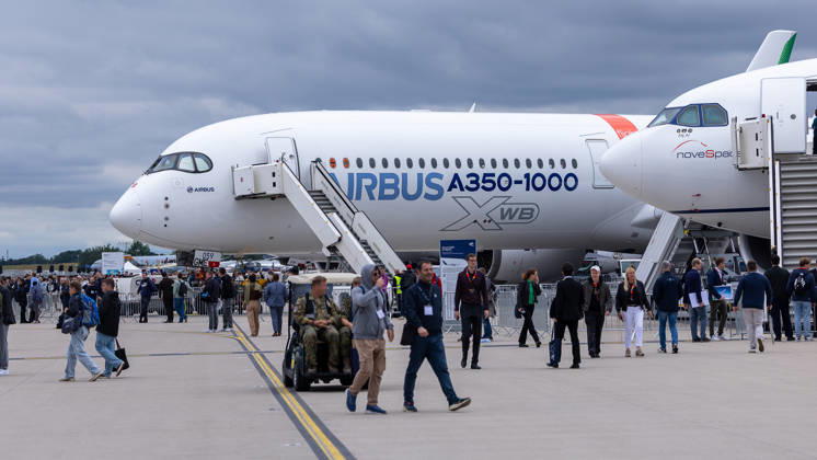 Trade visitor day at ILA Berlin 2026, Berlin, 12 06 2026 An Airbus A350 1000 XWB in the Airbus house livery stands on the exhibition apron of ILA Berlin Numerous trade visitors inspect the wide-body aircraft under overcast skies Schöneberg Berlin ExpoCenter Airport Brandenburg Germany 20260612-1V9A2969-M4000