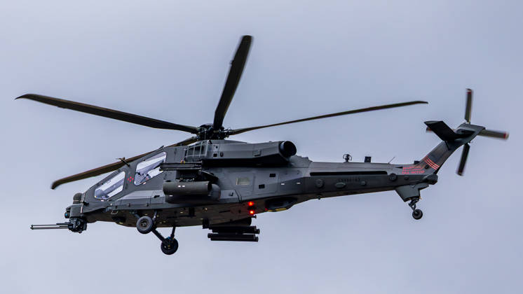 Trade visitor day at ILA Berlin 2026, Berlin, 12 06 2026 An armed Leonardo AW249 combat helicopter in flight against an overcast sky The aircraft bears the registration CSX82163 and is equipped with a nose cannon and weapon mounts under the fuselage Schöneberg Berlin ExpoCenter Airport Brandenburg Germany 20260612-1V9A3016-M4000