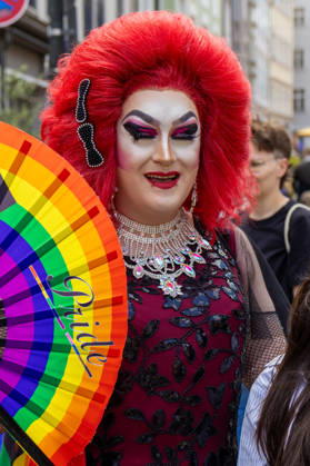 Augsburg, Bavaria, Germany June 13, 2026: Christopher Street Day (CSD) in Augsburg. The parade through the city center promotes the rights of LGBTQ+ people as well as social diversity and tolerance. A drag queen holds up a rainbow fan as an expression of creativity, self-expression, and the cultural diversity of the LGBTQ+ community