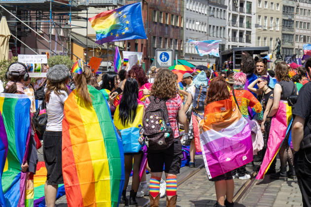 Augsburg, Bavaria, Germany June 13, 2026: Participants carrying rainbow flags and wearing colorful costumes take part in Christopher Street Day (CSD) in Augsburg. The parade through the city center promotes the rights of LGBTQ+ people as well as social diversity and tolerance. Several participants carry various Pride and identity flags