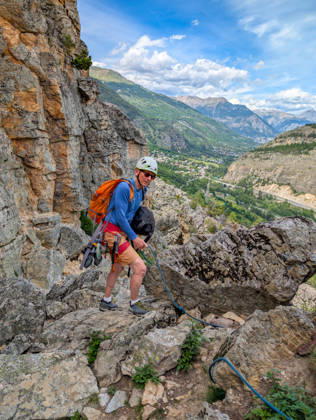Climbing in Casse de Prelles,detected_source_language in the French Alps a Person with Climbing equipment at a rocky Mountain trail Alps Mountain panorama at a blue Sky 1133302996 ,model released, Symbolfoto
