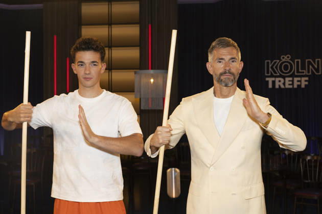Shaolin Kid Sacha WENK (left) and host Micky BEISENHERZ (right), with Bo Stangen, looking focused, portrait, guest appearance on the TV show Koelner Treff on WDR television, recorded on July 10, 2026, Aired on August 7, 2026