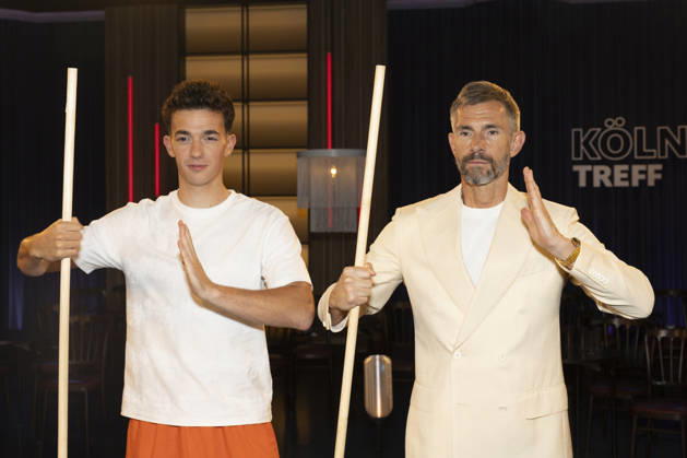 Shaolin Kid Sacha WENK (left) and host Micky BEISENHERZ (right), with Bo Stangen, looking focused, portrait, guest appearance on the TV show Koelner Treff on WDR television, recorded on July 10, 2026, Aired on August 7, 2026