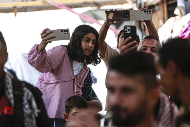 Gaza Families Celebrate Tawjihi Success A Palestinian girl records the gathering on a mobile phone as others hold up their phones during celebrations of the Tawjihi results in Gaza City, northern Gaza Strip, on July 23, 2026. Families in displacement camps and neighborhoods across northern Gaza City held modest celebrations for students who passed the Tawjihi examinations amid war, blockade and severe humanitarian conditions. Gaza Gaza Strip Palestinian Territories Copyright: xFaizxQreqax