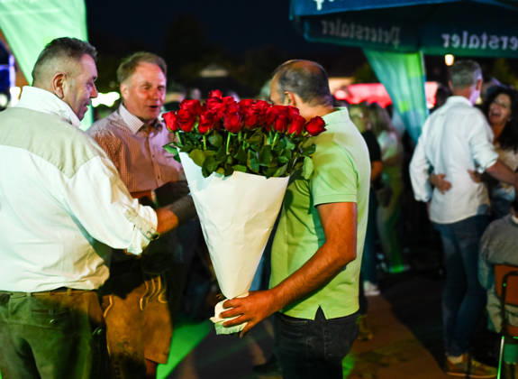 Freudenstadt, July 24, 2026: Black Forest Air Open Air Festival on the Market Square. A rose vendor on the sidelines of the main act, DJ Oetzi
