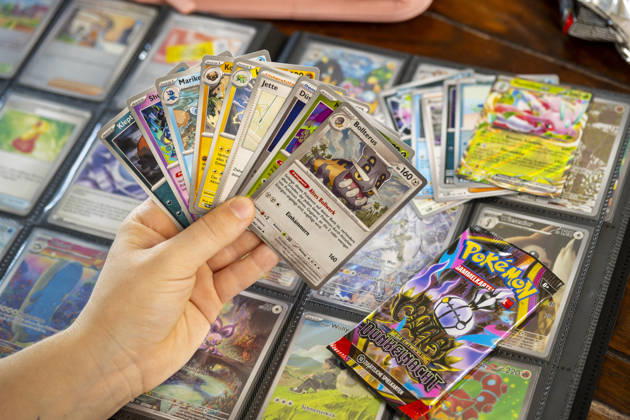 August 5, 2026, Germany, Bavaria, Pokémon Trading Cards, a teenage girl enthusiastically collects Pokémon cards in her album August 5, 2026, Pokémon August 5, 2026, Pokémon