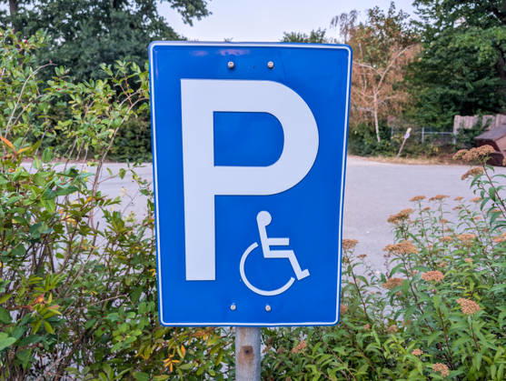 Bavaria, Germany - August 5, 2026: A traffic sign for a accessible parking space featuring a wheelchair symbol in a public parking lot. These designated spaces improve accessibility and enable people with disabilities to enjoy greater mobility and participate more fully in daily life