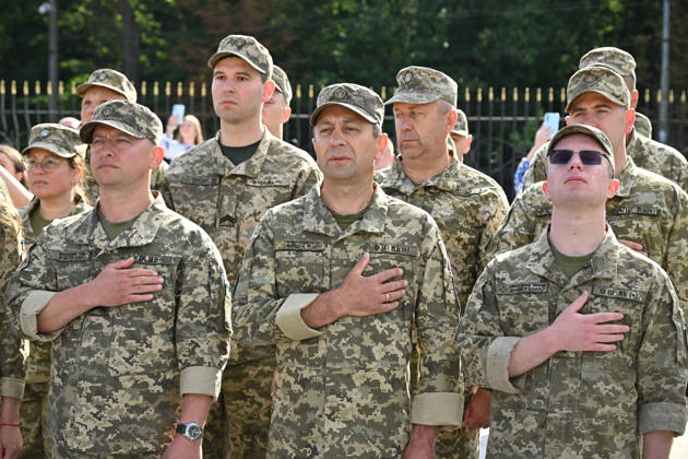National Flag Day of Ukraine in Lviv LVIV, UKRAINE - AUGUST 23: Ukrainian servicemen place their hands over their hearts during a National Flag Day ceremony in Lviv, Ukraine, on August 23, 2026. Due to the ongoing Russian-Ukrainian War, celebrations were limited to a ceremonial raising of the Ukrainian flag on the city s highest flagpole with the participation of soldiers from various branches of the armed forces. Participants also observed a minute of silence for those killed, sang the Ukrainian national anthem, and listened to patriotic and folk songs performed by a military orchestra. Michael Sorrow Anadolu Lviv Ukraine. Editorial use only. Please get in touch for any other usage.  Copyright: x2026xAnadoluxMichaelxSorrowx