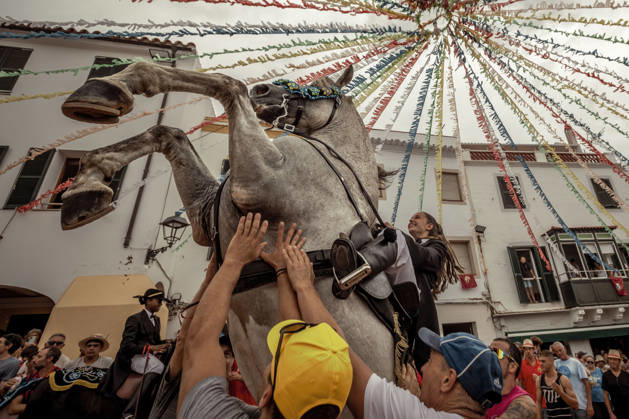 August 24, 2026, Ferreries, Menorca Balearic Islands, Spain: A caixer, or horse rider, rears his horse amid a cheering crowd during the traditional Jaleo at the Sant Bartomeu Festival in Ferreries. Ferreries Spain - ZUMAo105 20260824_fap_o105_010 Copyright: xMatthiasxOesterlex