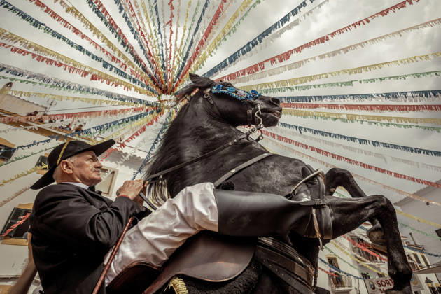 August 24, 2026, Ferreries, Menorca Balearic Islands, Spain: A caixer, or horse rider, rears his horse amid a cheering crowd during the traditional Jaleo at the Sant Bartomeu Festival in Ferreries. Ferreries Spain  - ZUMAo105 20260824_fap_o105_021 Copyright: xMatthiasxOesterlex
