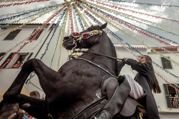 August 24, 2026, Ferreries, Menorca Balearic Islands, Spain: A caixer, or horse rider, rears his horse amid a cheering crowd during the traditional Jaleo at the Sant Bartomeu Festival in Ferreries. Ferreries Spain - ZUMAo105 20260824_fap_o105_014 Copyright: xMatthiasxOesterlex