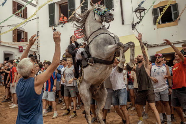 August 24, 2026, Ferreries, Menorca Balearic Islands, Spain: A caixer, or horse rider, rears his horse amid a cheering crowd during the traditional Jaleo at the Sant Bartomeu Festival in Ferreries. Ferreries Spain  - ZUMAo105 20260824_fap_o105_032 Copyright: xMatthiasxOesterlex