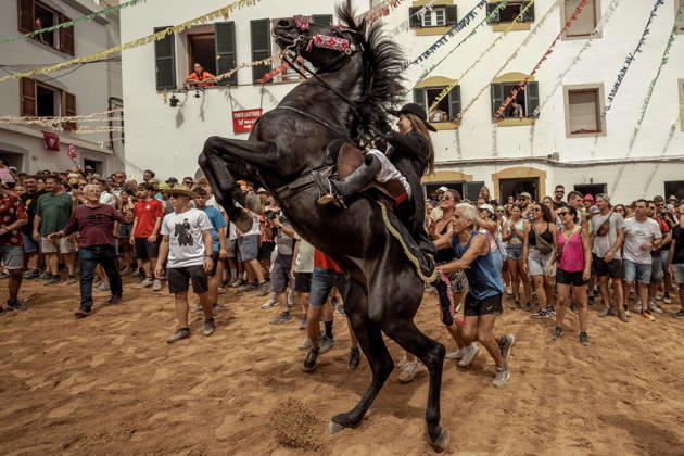 August 24, 2026, Ferreries, Menorca Balearic Islands, Spain: A caixer, or horse rider, rears his horse amid a cheering crowd during the traditional Jaleo at the Sant Bartomeu Festival in Ferreries. Ferreries Spain  - ZUMAo105 20260824_fap_o105_035 Copyright: xMatthiasxOesterlex