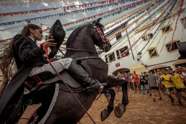 August 24, 2026, Ferreries, Menorca Balearic Islands, Spain: A caixer, or horse rider, rears his horse amid a cheering crowd during the traditional Jaleo at the Sant Bartomeu Festival in Ferreries. Ferreries Spain - ZUMAo105 20260824_fap_o105_016 Copyright: xMatthiasxOesterlex