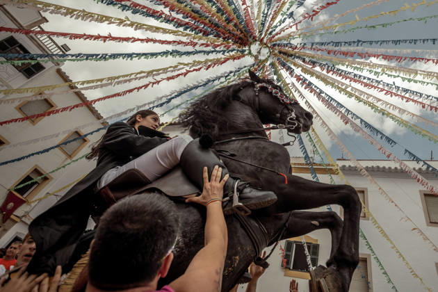 August 24, 2026, Ferreries, Menorca Balearic Islands, Spain: A caixer, or horse rider, rears his horse amid a cheering crowd during the traditional Jaleo at the Sant Bartomeu Festival in Ferreries. Ferreries Spain - ZUMAo105 20260824_fap_o105_024 Copyright: xMatthiasxOesterlex