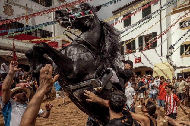 August 24, 2026, Ferreries, Menorca Balearic Islands, Spain: A caixer, or horse rider, rears his horse amid a cheering crowd during the traditional Jaleo at the Sant Bartomeu Festival in Ferreries. Ferreries Spain - ZUMAo105 20260824_fap_o105_028 Copyright: xMatthiasxOesterlex