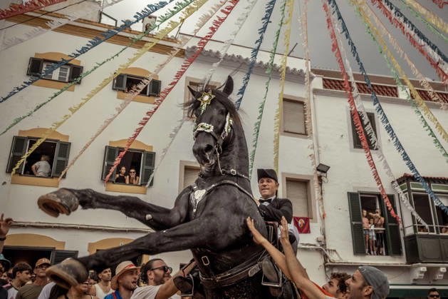 August 24, 2026, Ferreries, Menorca Balearic Islands, Spain: A caixer, or horse rider, rears his horse amid a cheering crowd during the traditional Jaleo at the Sant Bartomeu Festival in Ferreries. Ferreries Spain - ZUMAo105 20260824_fap_o105_031 Copyright: xMatthiasxOesterlex