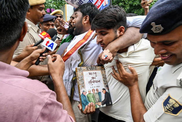 Protest Erupts in Bihar s Patna Patna, Aug 25 (ANI): A protester holds a copy of the Constitution during the protest, demanding the cancellation of the 70th BPSC examination, while condemning the alleged irregularities in the competitive examination, in Patna on Tuesday. Patna Bihar India Copyright: xANIx ANI_20260825097