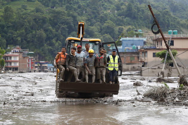August 26, 2026, Nuwakot, Nepal: Security personnel rescue people in a dozer from buildings and infrastructure that were damaged along the swollen Trishuli River following a massive flash flood triggered by an avalanche of ice and rock in the upper Lhende River on the Tibetan side, in Nuwakot district, Nepal, on Wednesday, August 26, 2026. The sudden flood swept through communities along the Bhote Koshi and Trishuli river systems, destroying homes, roads and bridges and leaving widespread devastation downstream. Nuwakot Nepal  - ZUMAg200 20260826_zap_g200_015 Copyright: xSkandaxGautamx