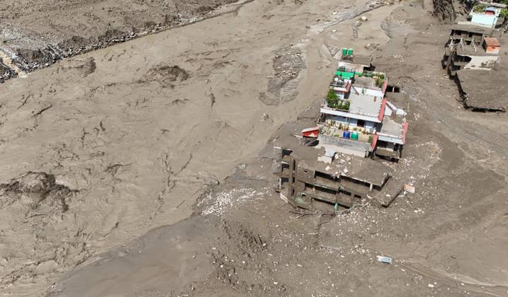August 26, 2026, Nuwakot, Nepal: An aerial view shows buildings and infrastructure damaged along the swollen Trishuli River following a massive flash flood triggered by an avalanche of ice and rock in the upper Lhende River on the Tibetan side, in Nuwakot district, Nepal, on Wednesday, August 26, 2026. The sudden flood swept through communities along the Bhote Koshi and Trishuli river systems, destroying homes, roads and bridges and leaving widespread devastation downstream. Nuwakot Nepal - ZUMAg200 20260826_zap_g200_013 Copyright: xSkandaxGautamx