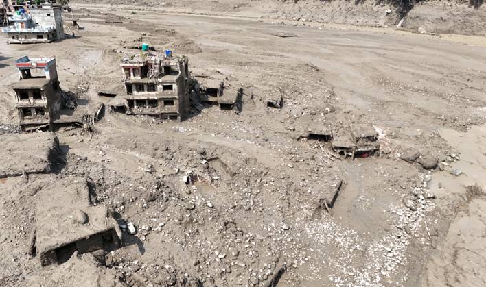 August 26, 2026, Nuwakot, Nepal: An aerial view shows buildings and infrastructure damaged along the swollen Trishuli River following a massive flash flood triggered by an avalanche of ice and rock in the upper Lhende River on the Tibetan side, in Nuwakot district, Nepal, on Wednesday, August 26, 2026. The sudden flood swept through communities along the Bhote Koshi and Trishuli river systems, destroying homes, roads and bridges and leaving widespread devastation downstream. Nuwakot Nepal - ZUMAg200 20260826_zap_g200_014 Copyright: xSkandaxGautamx
