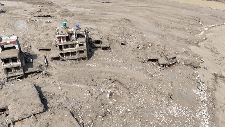 August 26, 2026, Nuwakot, Nepal: An aerial view shows buildings and infrastructure damaged along the swollen Trishuli River following a massive flash flood triggered by an avalanche of ice and rock in the upper Lhende River on the Tibetan side, in Nuwakot district, Nepal, on Wednesday, August 26, 2026. The sudden flood swept through communities along the Bhote Koshi and Trishuli river systems, destroying homes, roads and bridges and leaving widespread devastation downstream. Nuwakot Nepal  - ZUMAg200 20260826_zap_g200_021 Copyright: xSkandaxGautamx