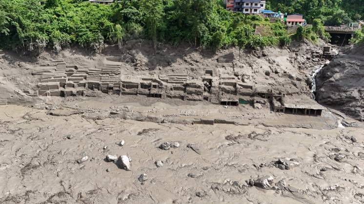 August 26, 2026, Nuwakot, Nepal: An aerial view shows buildings and infrastructure damaged along the swollen Trishuli River following a massive flash flood triggered by an avalanche of ice and rock in the upper Lhende River on the Tibetan side, in Nuwakot district, Nepal, on Wednesday, August 26, 2026. The sudden flood swept through communities along the Bhote Koshi and Trishuli river systems, destroying homes, roads and bridges and leaving widespread devastation downstream. Nuwakot Nepal - ZUMAg200 20260826_zap_g200_020 Copyright: xSkandaxGautamx