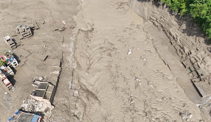 August 26, 2026, Nuwakot, Nepal: An aerial view shows buildings and infrastructure damaged along the swollen Trishuli River following a massive flash flood triggered by an avalanche of ice and rock in the upper Lhende River on the Tibetan side, in Nuwakot district, Nepal, on Wednesday, August 26, 2026. The sudden flood swept through communities along the Bhote Koshi and Trishuli river systems, destroying homes, roads and bridges and leaving widespread devastation downstream. Nuwakot Nepal - ZUMAg200 20260826_zap_g200_023 Copyright: xSkandaxGautamx