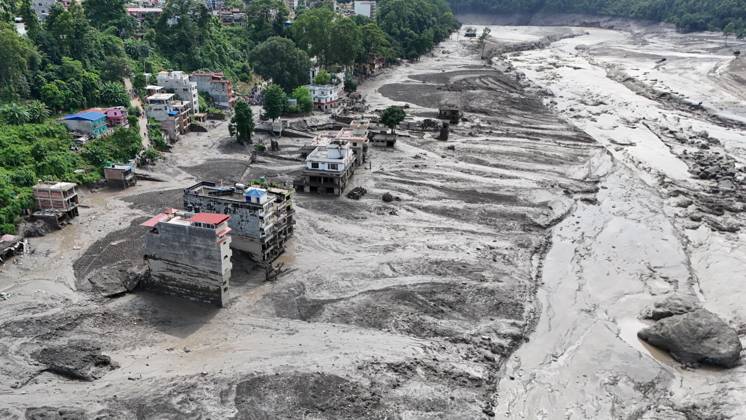 August 26, 2026, Nuwakot, Nepal: An aerial view shows buildings and infrastructure damaged along the swollen Trishuli River following a massive flash flood triggered by an avalanche of ice and rock in the upper Lhende River on the Tibetan side, in Nuwakot district, Nepal, on Wednesday, August 26, 2026. The sudden flood swept through communities along the Bhote Koshi and Trishuli river systems, destroying homes, roads and bridges and leaving widespread devastation downstream. Nuwakot Nepal - ZUMAg200 20260826_zap_g200_018 Copyright: xSkandaxGautamx