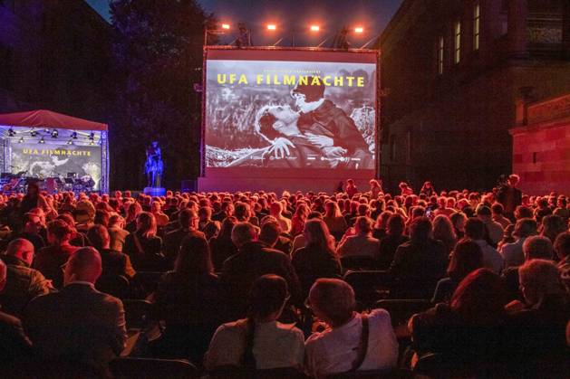 ABB FILM NIGHT Overview with movie screen; guests and visitors at the opening reception for the 2026 UFA Film Nights on the rooftop terrace of Bertelsmann Repraesentanz on August 26, 2026, in Berlin, Germany