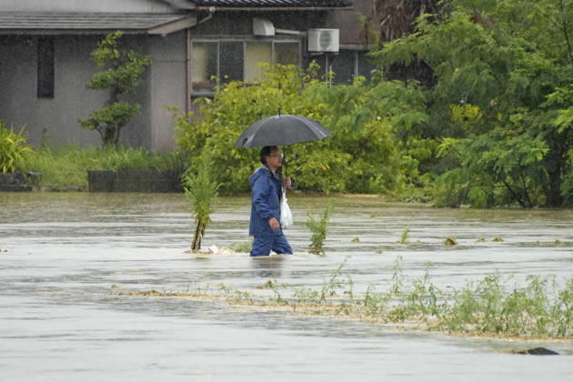 Torrential rain in central Japan A man walks on a flooded street in Himi in Toyama Prefecture, central Japan, on Aug. 27, 2026, following torrential rain.  A14AA0005626692P