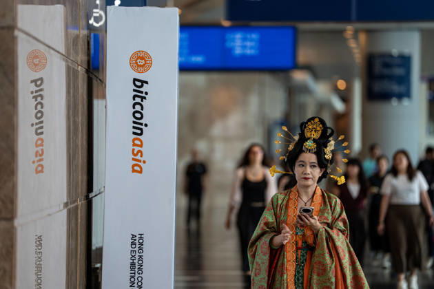 Bitcoin Asia Hong Kong 2026 A woman dress in a Chinese Hanfu walking next to a Bitcoin Asia logo at Bitcoin Asia 2026 on August 27, 2026 in Hong Kong. (Photo by Vernon Yuen Nexpher Images) HONG KONG
