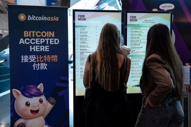 Bitcoin Asia Hong Kong 2026 Two woman looking at a menu next to a sign saying Bitcoin accepted at Bitcoin Asia 2026 on August 27, 2026 in Hong Kong. (Photo by Vernon Yuen Nexpher Images) HONG KONG