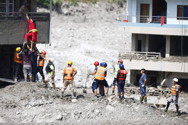 August 28, 2026, Nuwakot, Nepal: A woman climbs on top of her home to retrieve goods following flash floods at Devighat in Bidur Municipality, Nuwakot district, Nepal, on Thursday, August 27, 2026. The floods, triggered by a glacial collapse and debris flow upstream, have killed at least 270 people and left 826 others out of contact, according to Nepalese authorities, with search and rescue operations continuing. Nuwakot Nepal - ZUMAg200 20260828_zap_g200_002 Copyright: xSkandaxGautamx