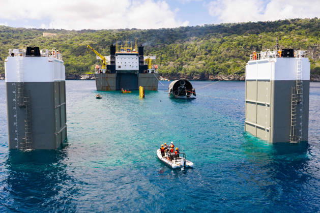 SpaceX engineers spent several days inspecting Ship 40 in the waters off Christmas Island as seen in pictures released on Thursday, August 27, 2026. They collected heatshield samples and gained vital insight into how the vehicle handled reentry, with improvements now planned for future vehicles. Starship has now been loaded onto a semi-submersible ship to begin the several-month journey back to Starbase.  WAX2026082705 SPACEX