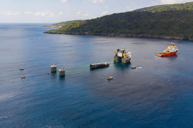 SpaceX engineers spent several days inspecting Ship 40 in the waters off Christmas Island as seen in pictures released on Thursday, August 27, 2026. They collected heatshield samples and gained vital insight into how the vehicle handled reentry, with improvements now planned for future vehicles. Starship has now been loaded onto a semi-submersible ship to begin the several-month journey back to Starbase.  WAX2026082706 SPACEX