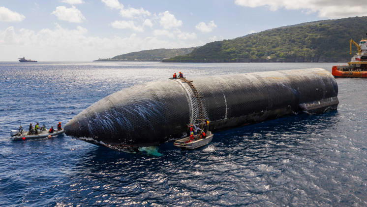 SpaceX engineers spent several days inspecting Ship 40 in the waters off Christmas Island as seen in pictures released on Thursday, August 27, 2026. They collected heatshield samples and gained vital insight into how the vehicle handled reentry, with improvements now planned for future vehicles. Starship has now been loaded onto a semi-submersible ship to begin the several-month journey back to Starbase.  WAX2026082701 SPACEX