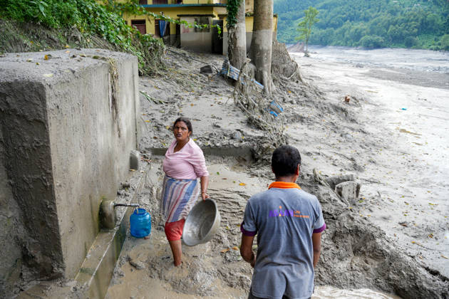 Nepal Flash Flood Leaves Hundreds Missing in Himalayan Border District A local resident cleans debris from a drinking water tap following flash floods in Devighat, Nuwakot, Nepal, on August 27, 2026. Kathmandu Nepal  Copyright: xSunilxPradhanx originalFilename: pradhan-nepalchi260827_npnS4.jpg