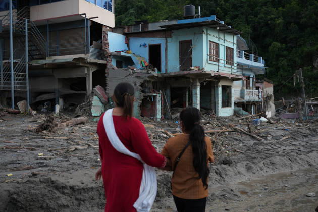 Nepal Flash Flood Leaves Hundreds Missing in Himalayan Border District Women walk past a house damaged by flash floods in Devighat, Nuwakot, Nepal, on August 27, 2026. Kathmandu Nepal  Copyright: xSunilxPradhanx originalFilename: pradhan-nepalchi260827_npuZ9.jpg