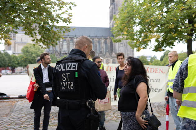 Migra-Streik rally against racism and social exclusion in Germany s Magdeburg MAGDEBURG, GERMANY - AUGUST 27: A police officer speaks with a participant during a rally against racism and social exclusion outside the Saxony-Anhalt state parliament at Domplatz in Magdeburg, Germany, on August 27, 2026. The rally was held as part of the Migra-Streik, during which participating migrant-run businesses across the city voluntarily closed their doors to call for solidarity and the protection of a free and democratic society. Somaya Abdelrahman Anadolu Magdeburg Germany. Editorial use only. Please get in touch for any other usage.  Copyright: x2026xAnadoluxSomayaxAbdelrahmanx