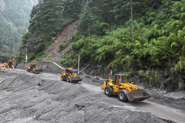 SHIGATSE, CHINA - AUGUST 28: Excavators and loaders move towards a damaged road section to begin debris clearance operations on August 28, 2026 in Shigatse, Xizang Autonomous Region of China. Traffic departments have organized forces to carry out emergency repair work on the affected section of National Highway G216 leading to Gyirong Port following a mudslide on the Nepal side on August 26 that caused casualties and missing persons.  Copyright: xChinaxNewsxServicex 111662595429