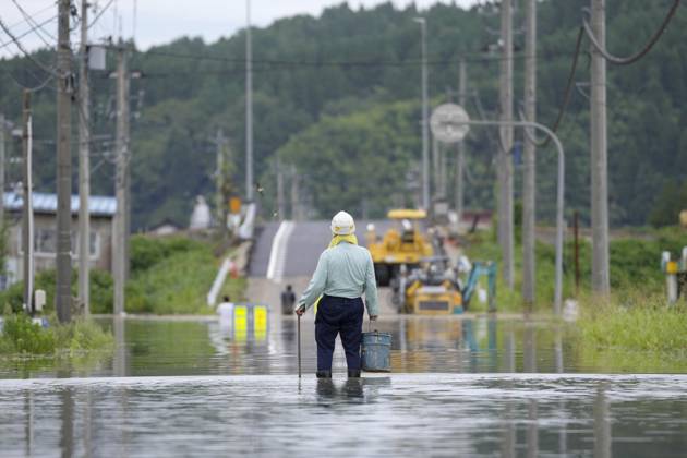 Torrential rain in central Japan A person stands on a submerged street in Himi in Toyama Prefecture, central Japan, on Aug. 28, 2026, following torrential rain.  A14AA0005626749P