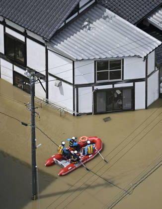 Torrential rain in central Japan Photo taken from a Kyodo News helicopter on Aug. 28, 2026, shows rescuers riding on a boat in a submerged area in Himi in Toyama Prefecture, central Japan, following torrential rain.  A14AA0005626755P