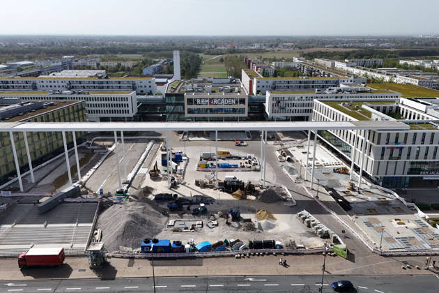 Redesign of Willy Brandt Platz at the Riem Arcaden: Sealed Surfaces Are Being Converted into Green Spaces Construction work is underway to redesign Willy Brandt Platz in front of the Riem Arcaden in Munich. As part of the redesign, previously sealed surfaces will be unsealed and replaced with green spaces. Construction barriers