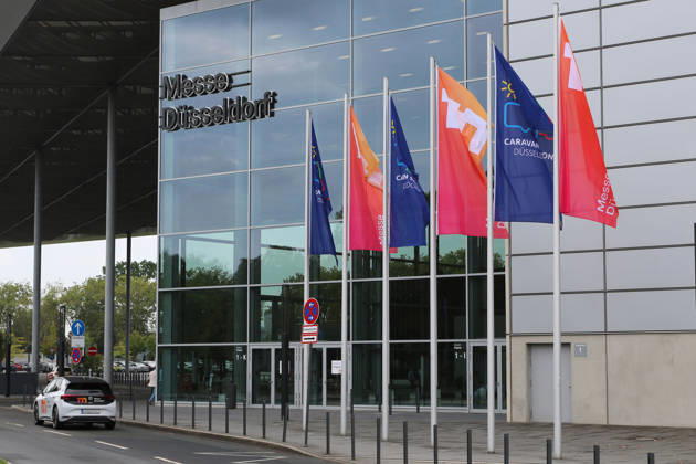 Flags in front of the South Entrance to Messe Düsseldorf, Caravan Salon Düsseldorf August 28–September 6, 2026, Messe Düsseldorf, the world’s leading trade fair for mobile travel, the world’s largest trade fair for motorhomes and caravans, camping and caravanning, mobile vacations, Düsseldorf D