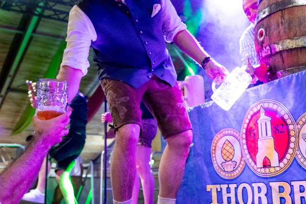 Augsburg, Bavaria, Germany August 28, 2026: Opening of the Plärrer in Augsburg. After the traditional tapping of the keg, free beer is served at the Augsburg Herbstplärrer. Visitors hold out their beer mugs toward the stage and have beer poured directly from the keg