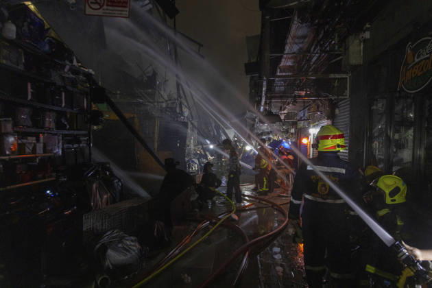 Bangkok Fire Engulfs Klongthom Centre Firefighters direct multiple water streams through a debris-filled passage inside the fire-damaged market complex at Klongthom Centre on Worachak Road in Pom Prap Sattru Phai, Bangkok, Thailand, on August 28, 2026. The fire was reported at 8:42 p.m. at Klongthom Centre on Worachak Road, where flames spread from a ground-floor shop across the ground floor and mezzanine beneath the parking area; parts of the structure subsided, several emergency personnel were injured, and firefighters brought the blaze under control at about 11:15 p.m. Bangkok Bangkok Thailand Copyright: xNicolaxLongobardix
