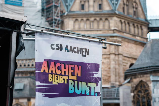 Germany, Aachen CSD, Aachen Pride 2026, Christopher Street Day, parade, equality, anti-queer sentiment, trans rights, equal rights, banners, Aachen Remains Colorful in front of Aachen Cathedral Copyright: xThiemoxRudolphx